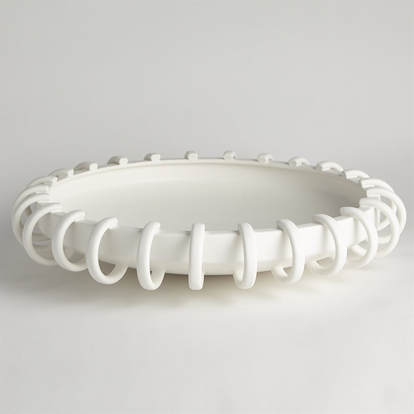 White ceiling light fixture with decorative design on a gray background