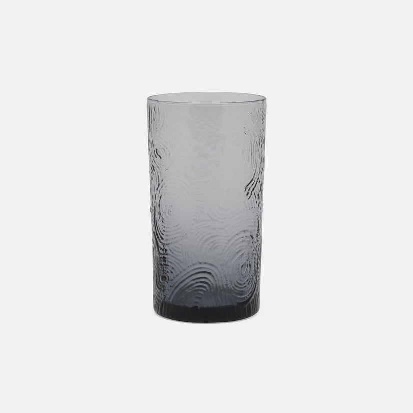 Gray textured glass tumbler on a white background