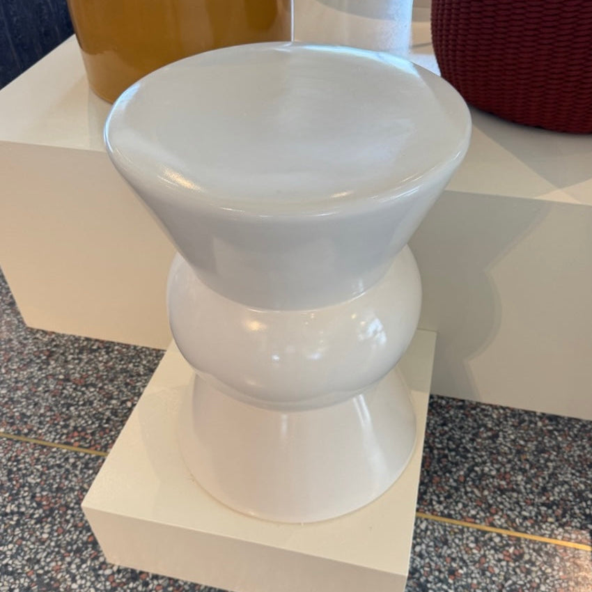 White ceramic bowl on a pedestal stand with a blurred background