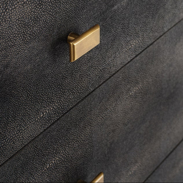 Close-up of a dark mushroom textured drawer with a rectangular gold pull handle, showing the fine grain pattern of the drawer front.