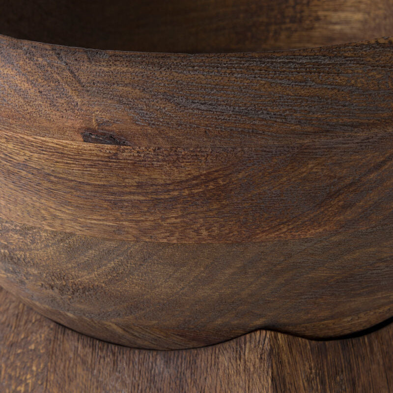 Close-up of a dark brown wooden bowl showing the rich wood grain texture and curved interior edge.