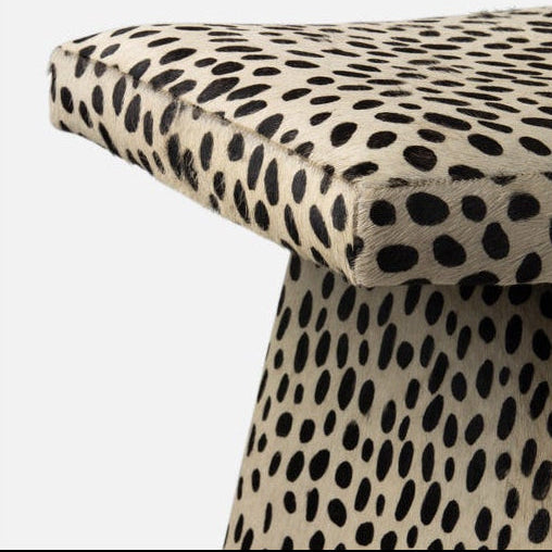 Stool with cheetah print pattern on a white background