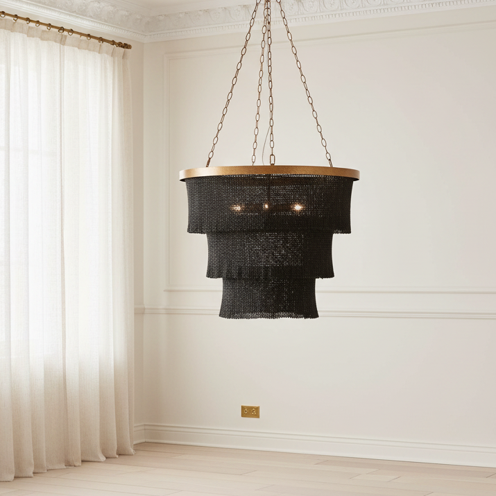 Black chandelier hanging in a room with white walls and curtains.