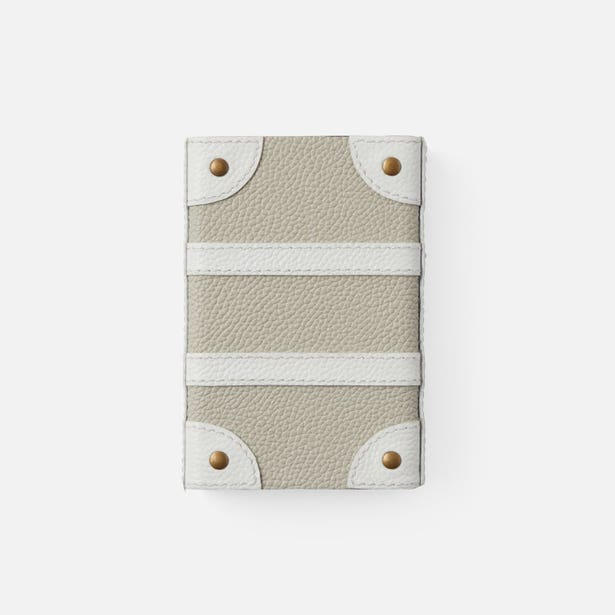 Small leather pouch with white stripe and gold accents on a light gray background