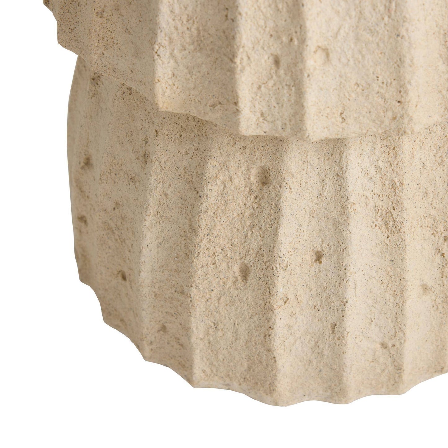 Close-up of a textured stone surface with visible cracks and variations in color.