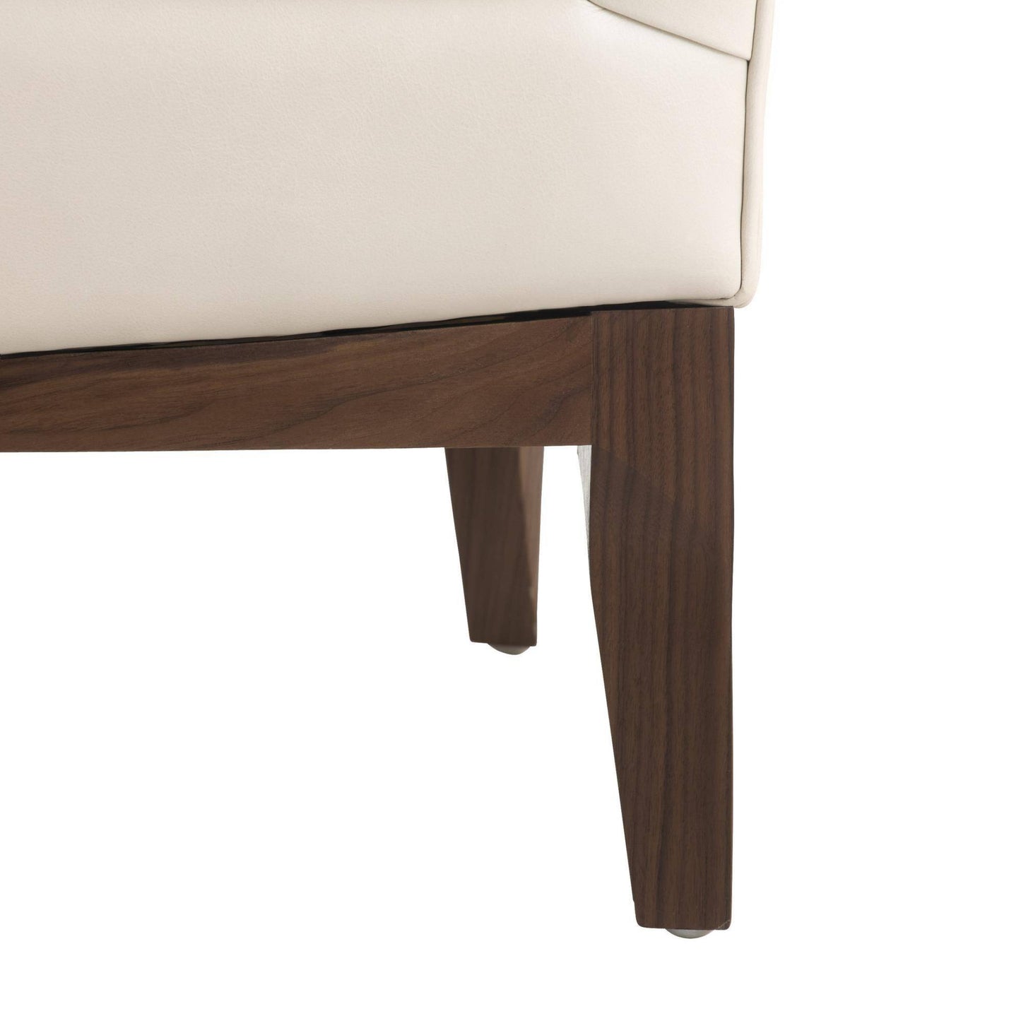 Close-up of a wooden leg of a white sofa on a white background