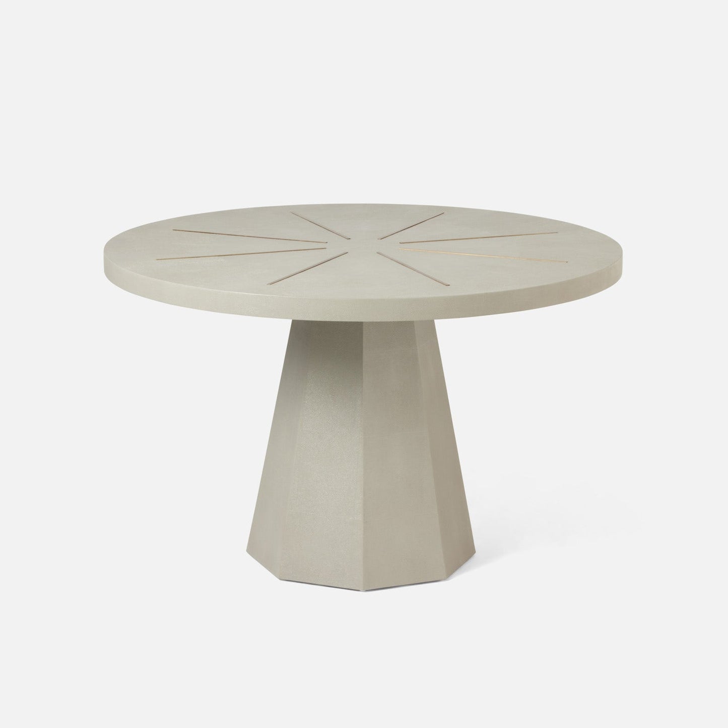 Round beige table with a geometric base on a white background