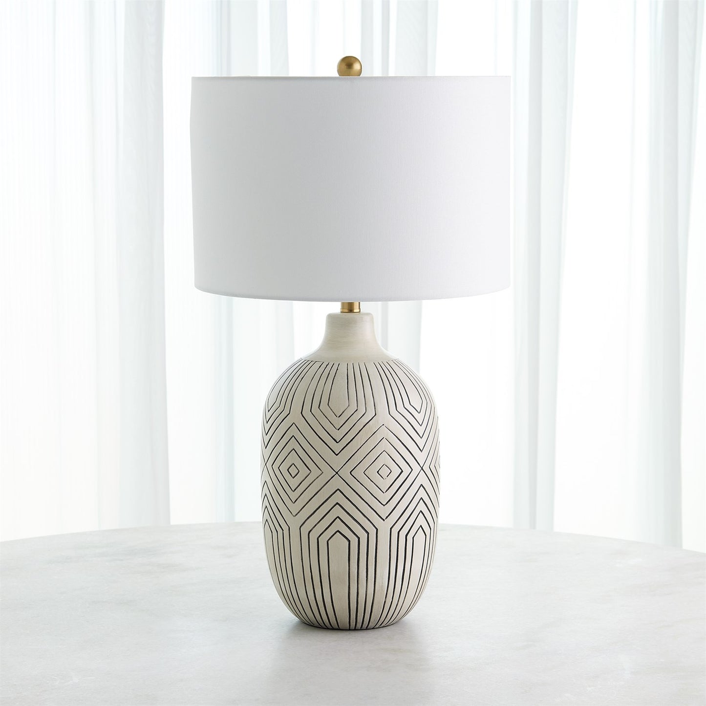 Decorative lamp with geometric pattern on a white surface and light background