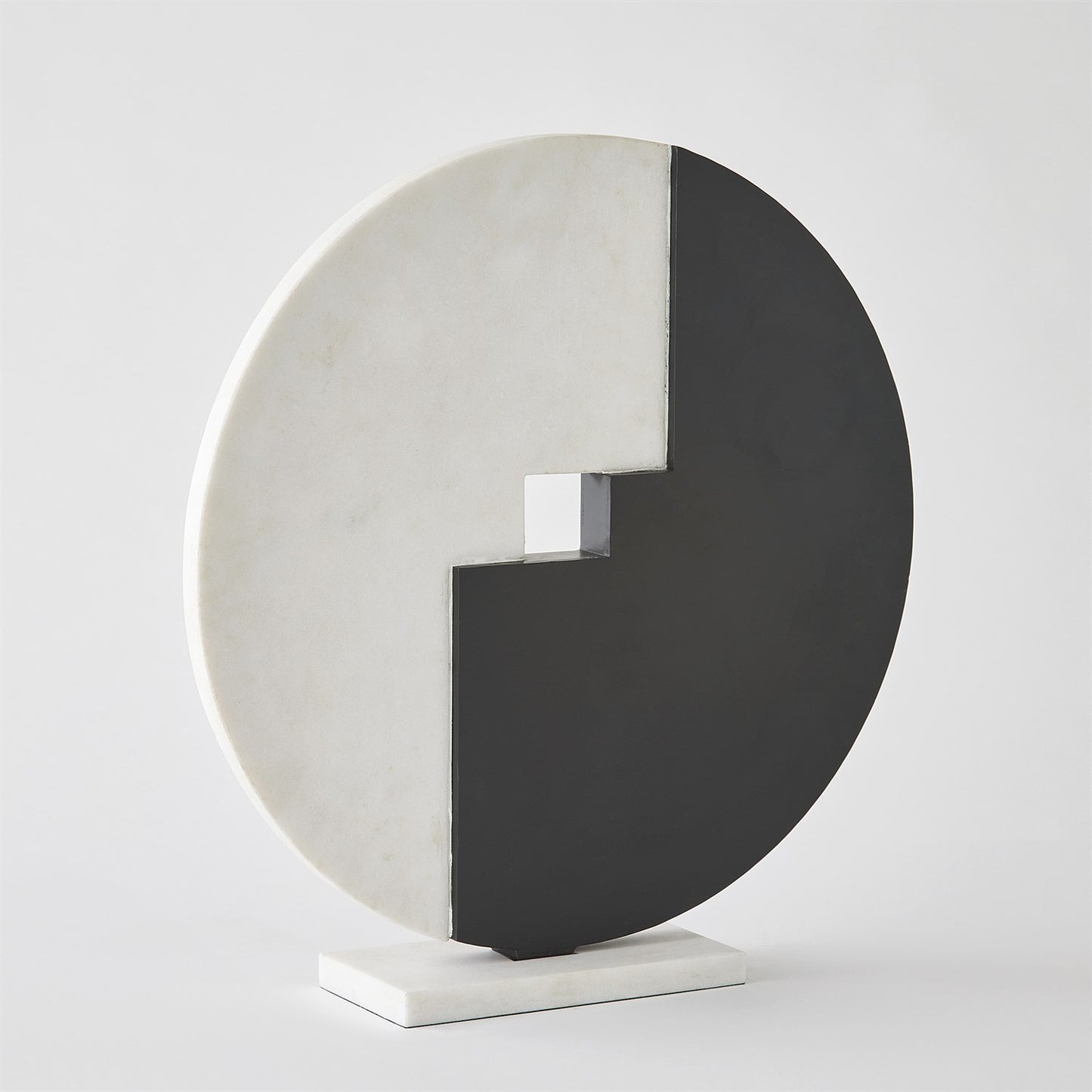 Abstract sculpture with circular design on a white background