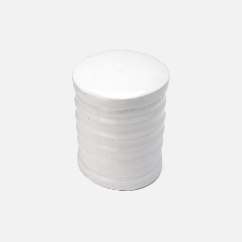 White cylindrical container with cotton pads on a white background