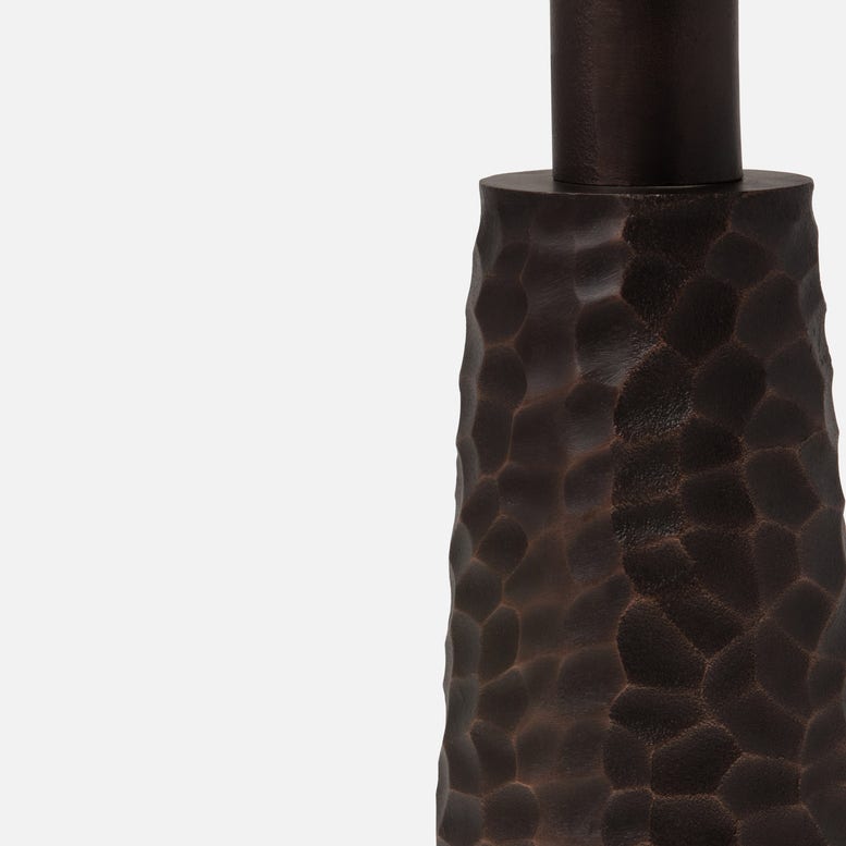 Textured dark brown vase on a light gray background
