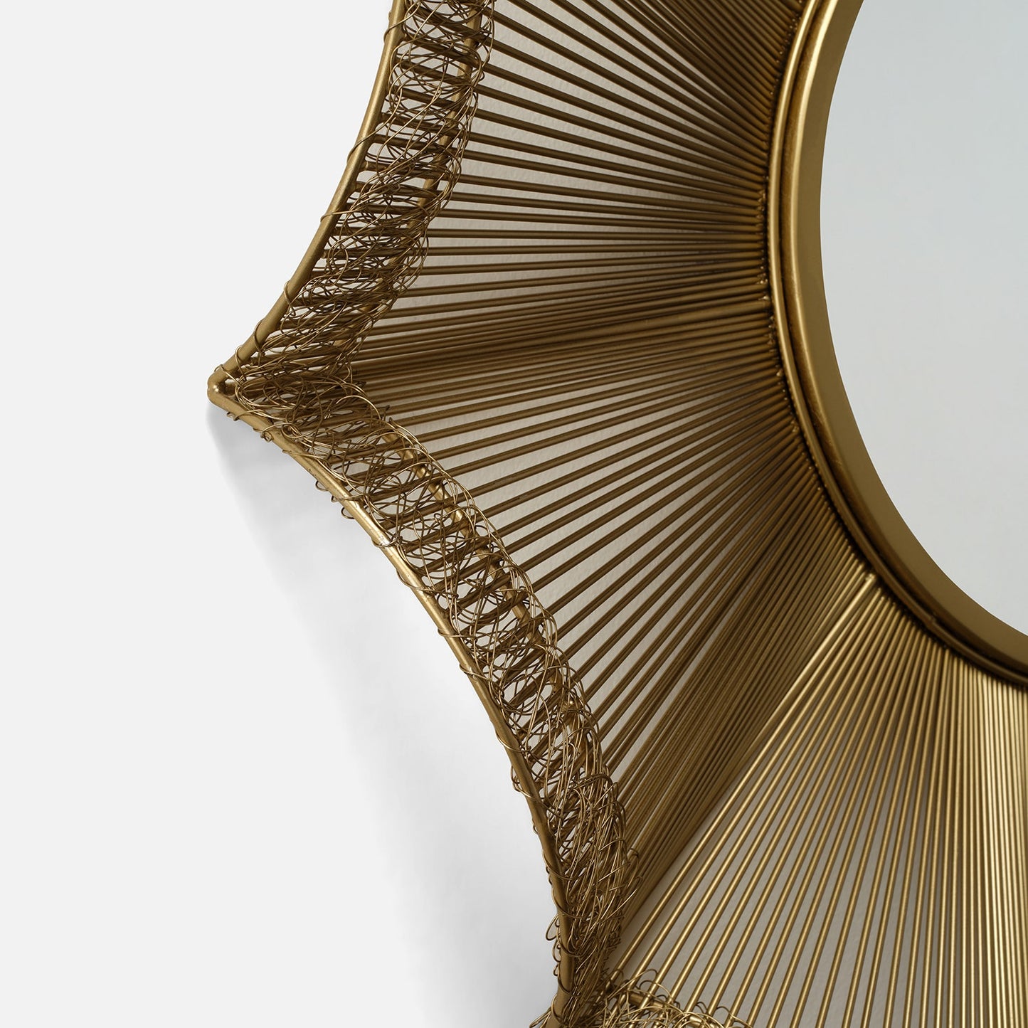 Gold decorative wall mirror with intricate design on a white background