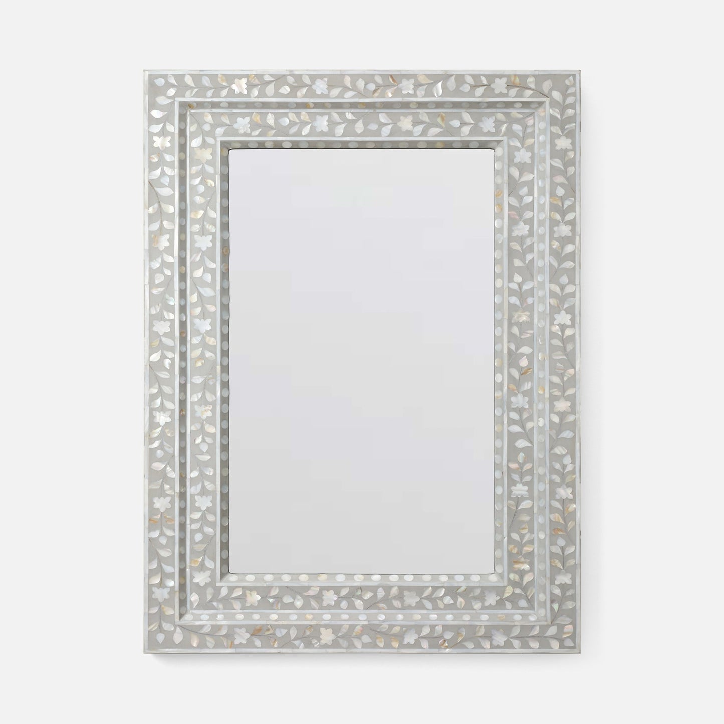 A rectangular wall mirror with an ornate silver frame made of inlay mosaic shell-like pieces in a leaf pattern, shown against a plain light gray background.