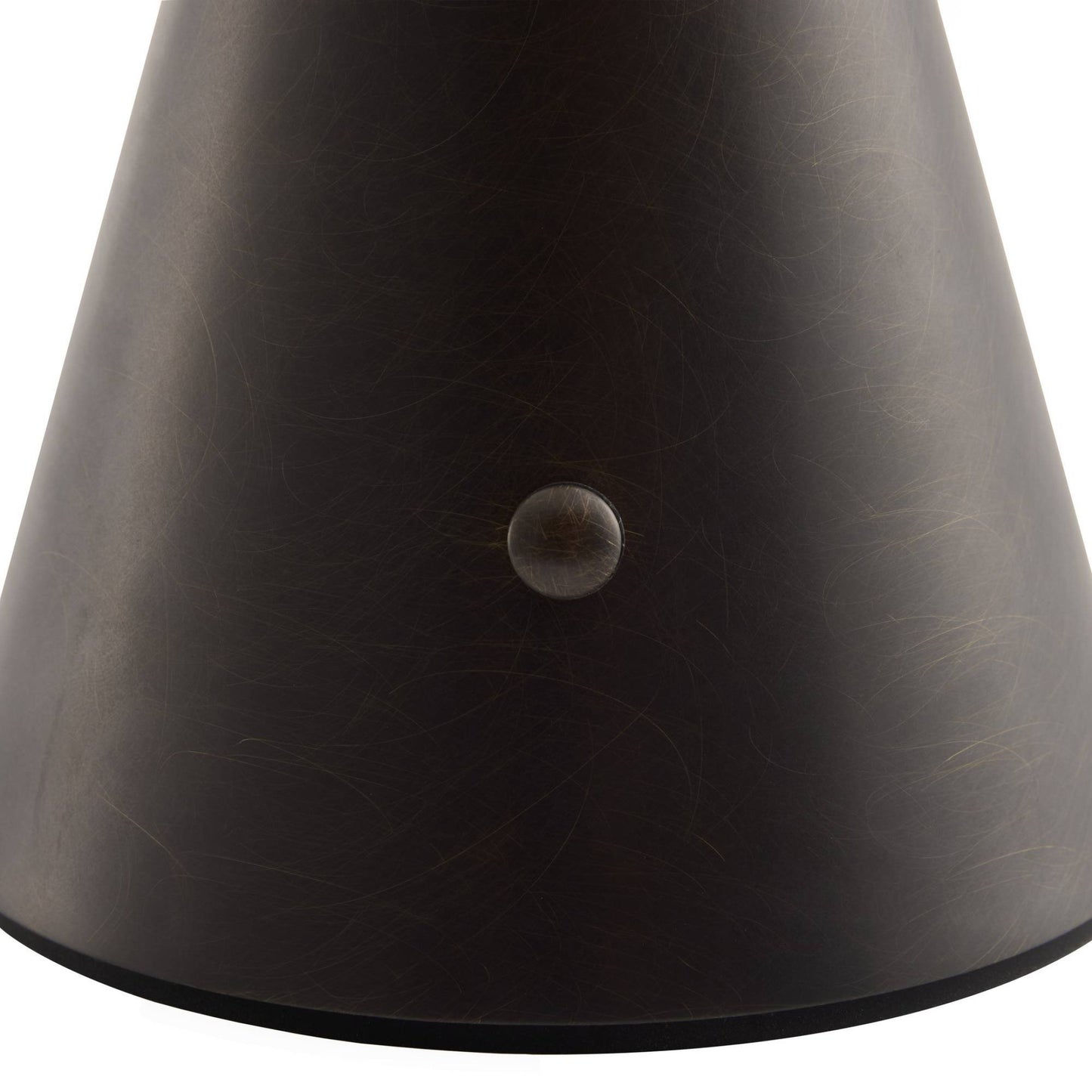 Close-up of a dark brown leather product with a button on a white background