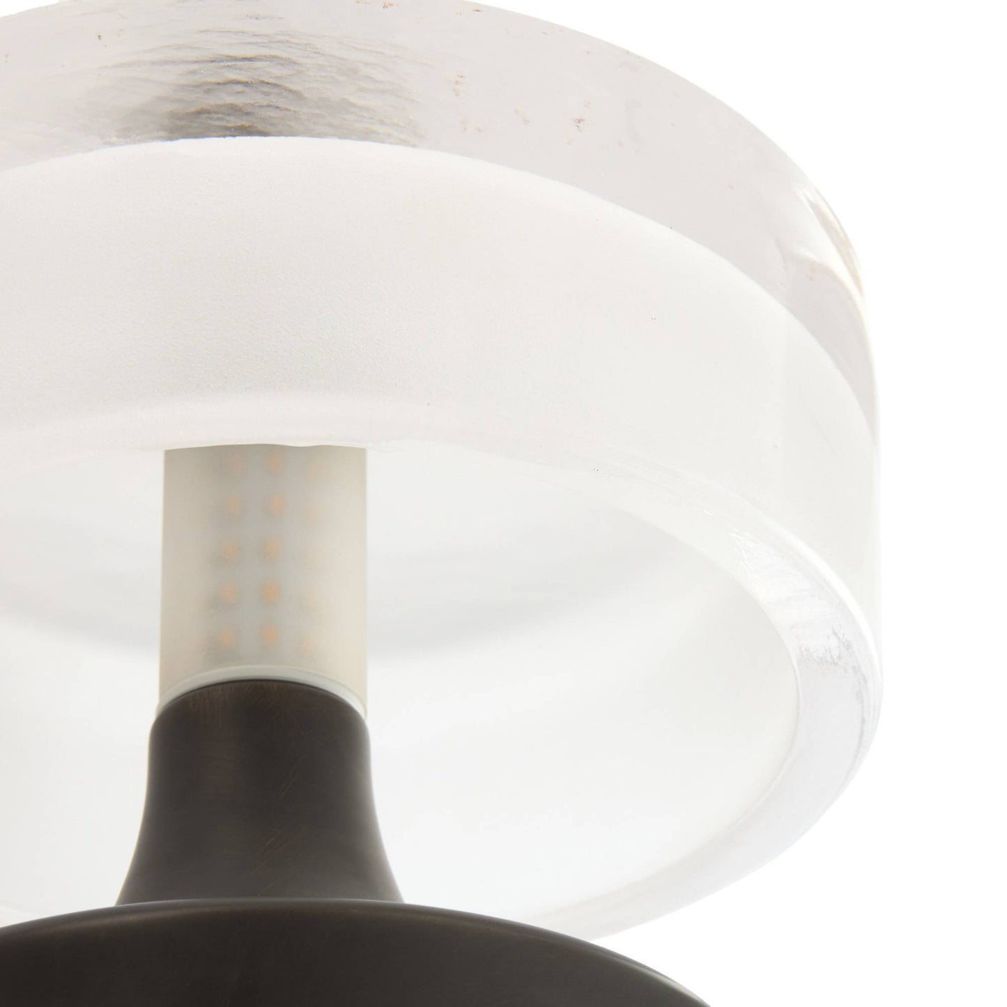 Close-up of a light fixture with a white shade and black base on a white background