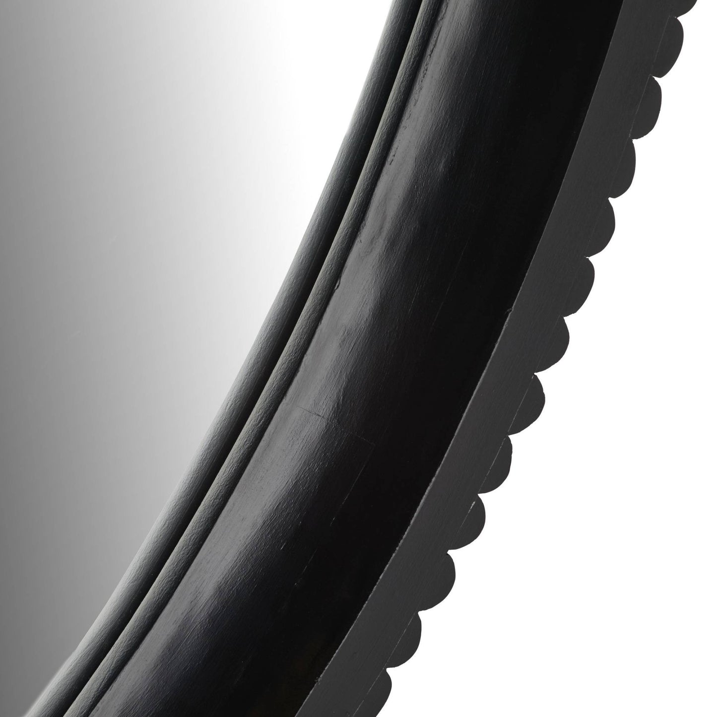 Close-up of a black circular object with a reflective surface on a white background