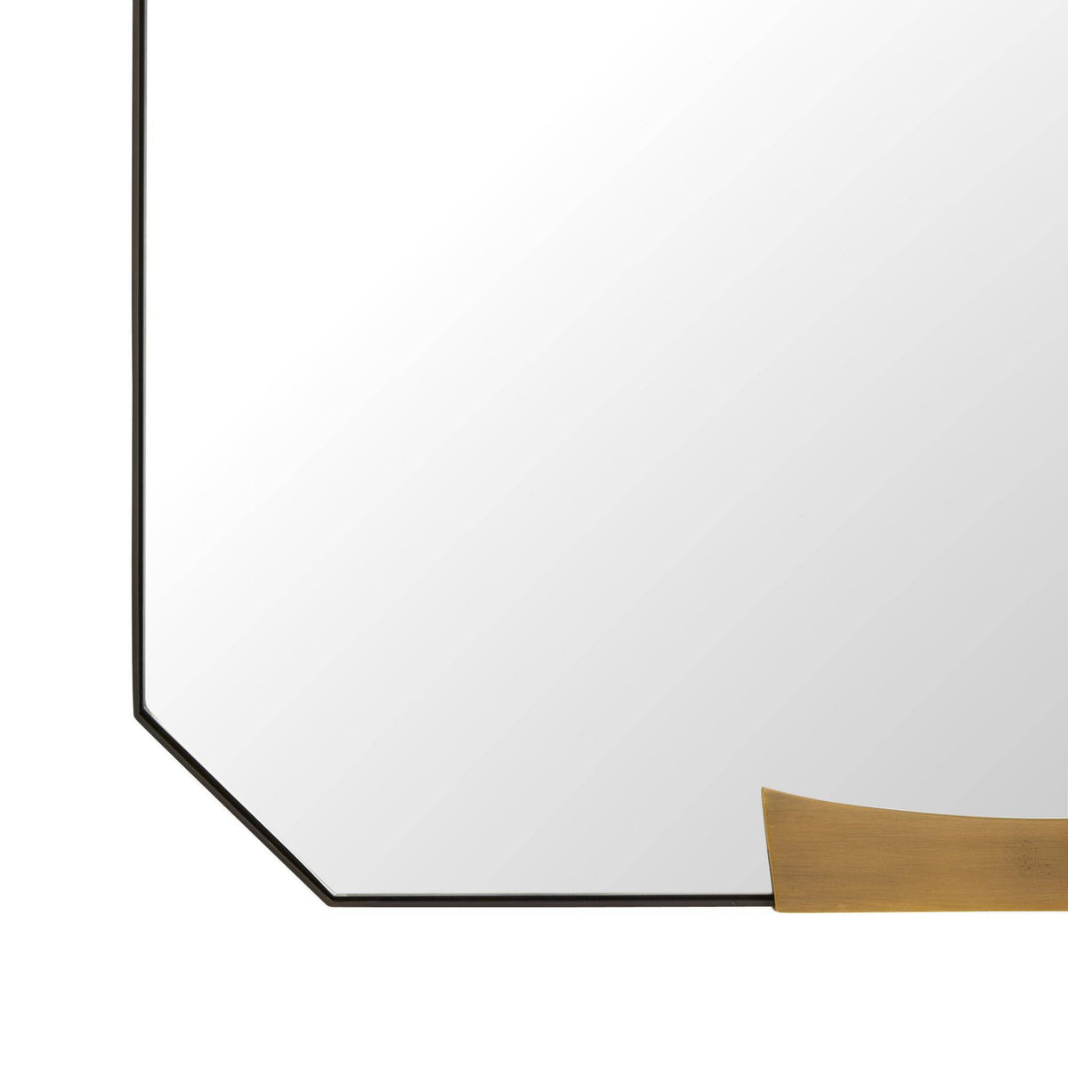 close up of a tall, narrow rectangular floor mirror with rounded corners and small gold-toned metal accents at the top and bottom, shown on a plain white background.