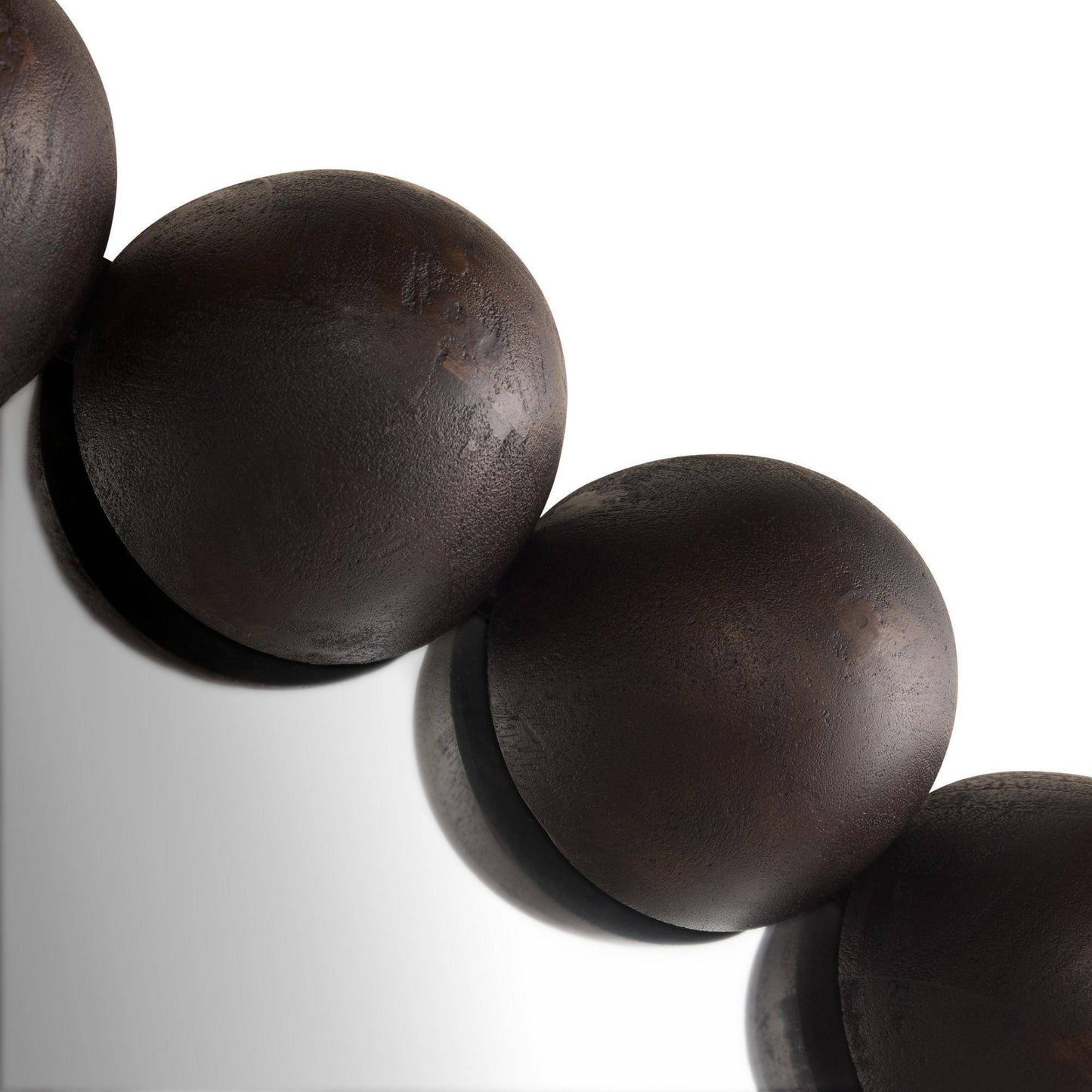 Close-up of dark wooden beads on a white background