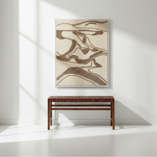 brown coco bead wall art hanging over a mahogany bench wrapped in full grain leather