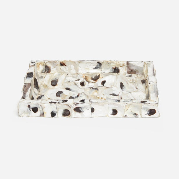 A rectangular resin tray with a textured, organic pattern of black, brown, and beige spots on a translucent white base, photographed on a light gray background.