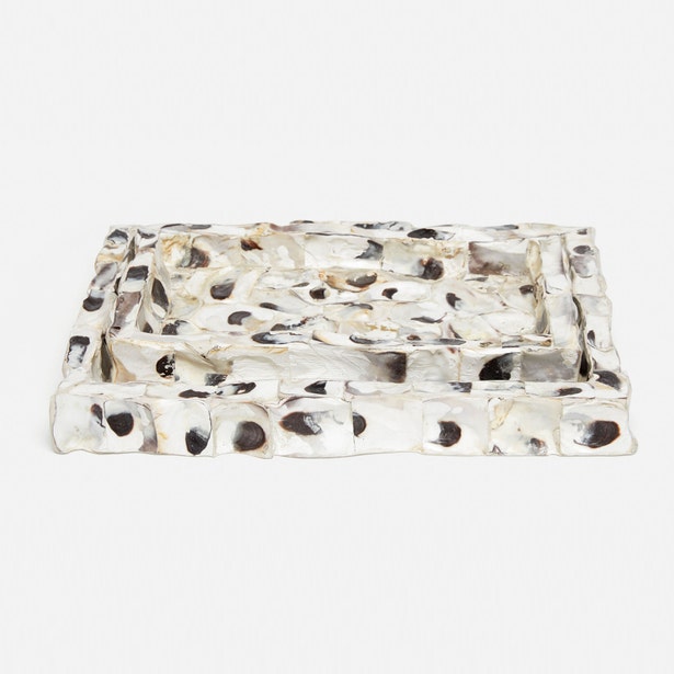 A rectangular resin tray with a raised textured border, featuring a translucent white base with black and beige organic inclusions, photographed on a seamless white background.