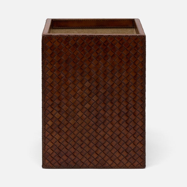 A rectangular dark brown woven leather box with an open top, shown against a plain light gray background.