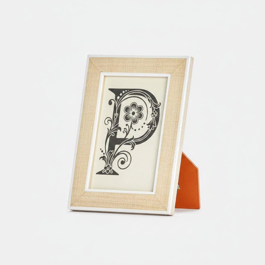 Framed artwork with a decorative letter 'P' on a white background