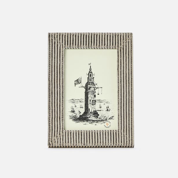Framed artwork of a lighthouse on a white background