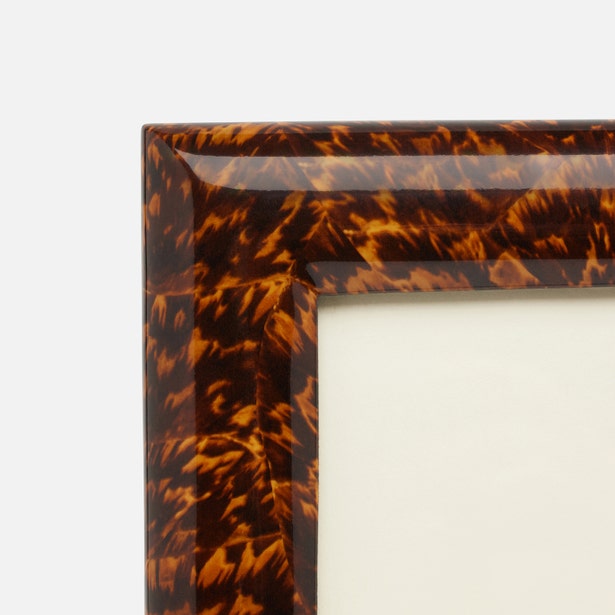 Tortoiseshell patterned picture frame on a white background