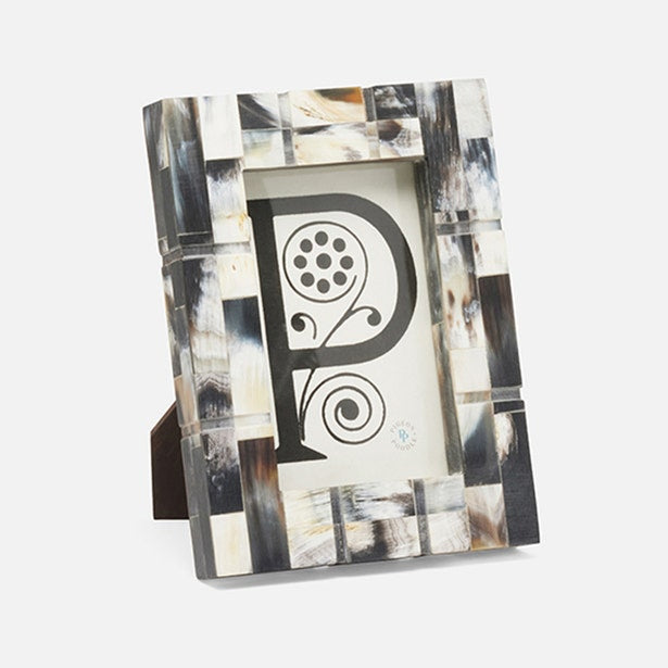 Decorative photo frame with abstract design and letter 'P' on a white background