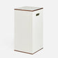 White laundry basket with brown trim on a white background