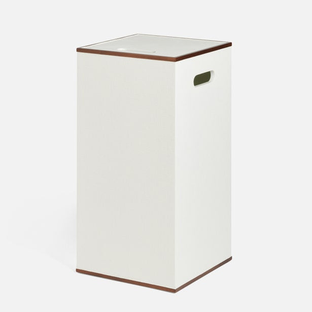 White laundry basket with brown trim on a white background