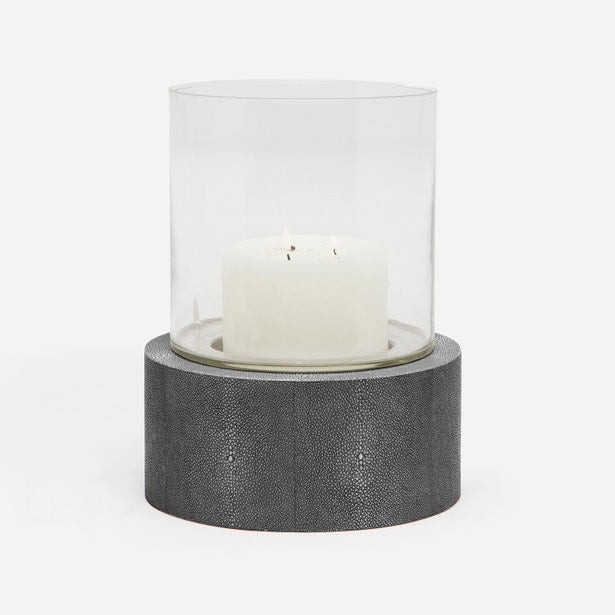 Cylindrical candle holder with glass cover and textured base on a white background