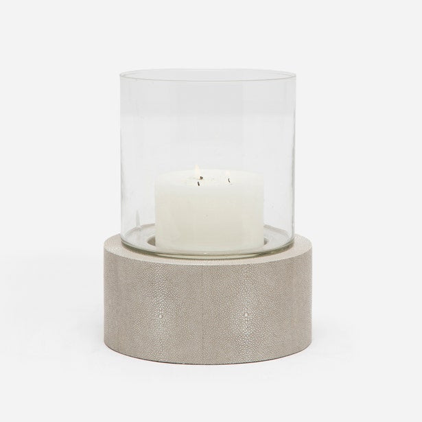 Candle holder with a white candle on a light gray background