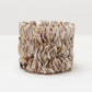 Textured ceramic candle holder on a white background