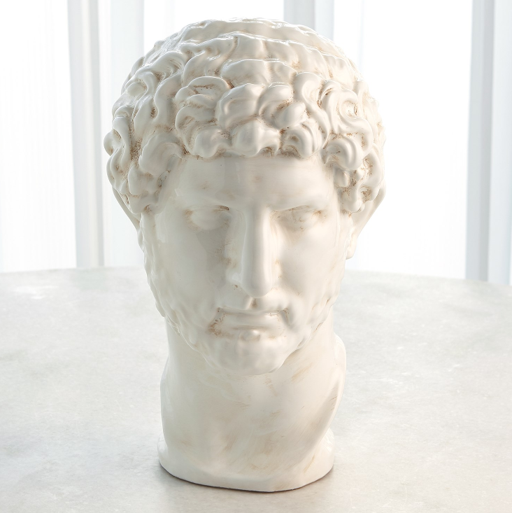 White marble bust of a classical figure on a light background