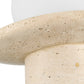 Close-up of a textured stone-like surface with a white base.