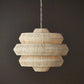 Rattan pendant light hanging against a dark background