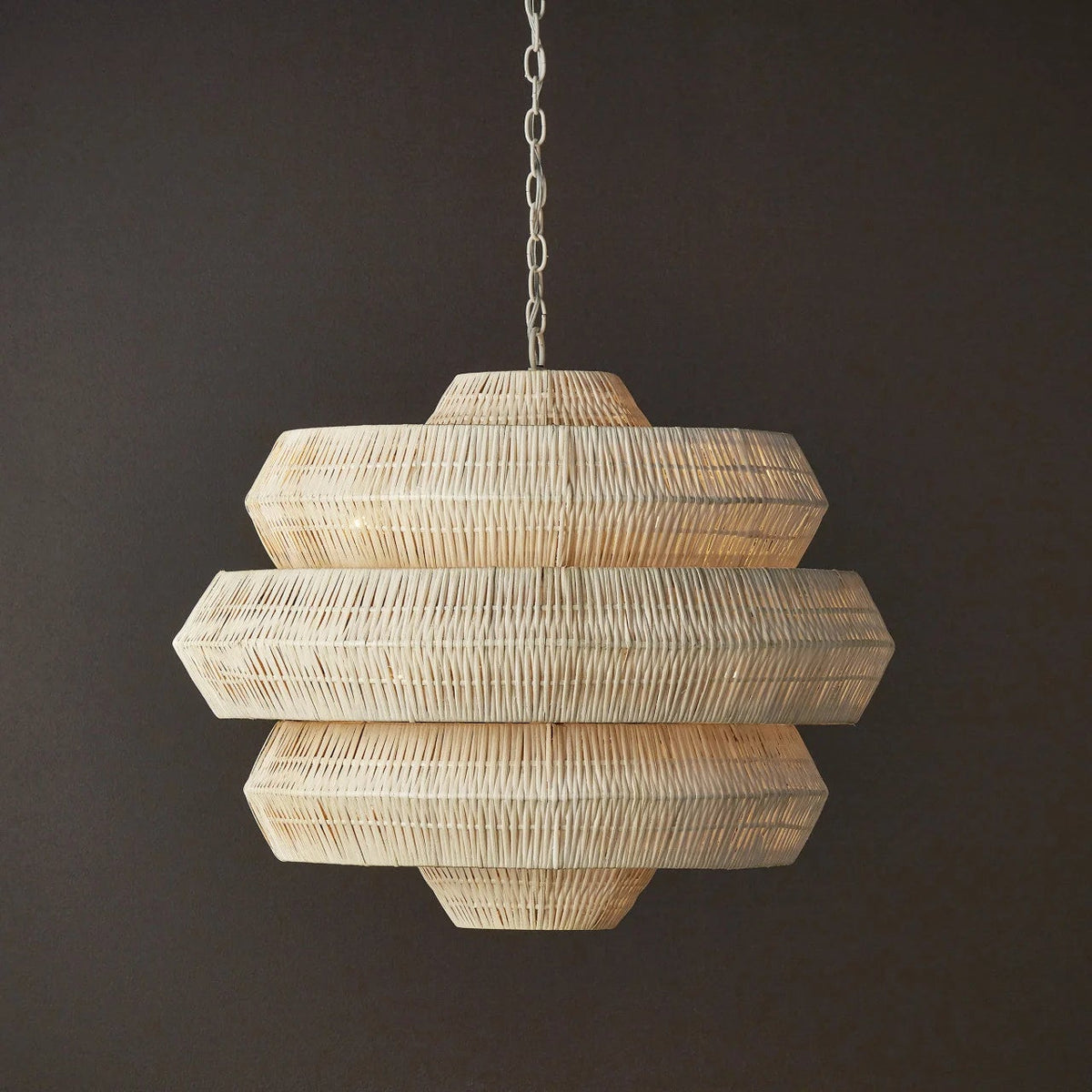 Rattan pendant light hanging against a dark background