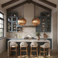 Modern kitchen with pendant lights, bar stools, and a marble countertop.