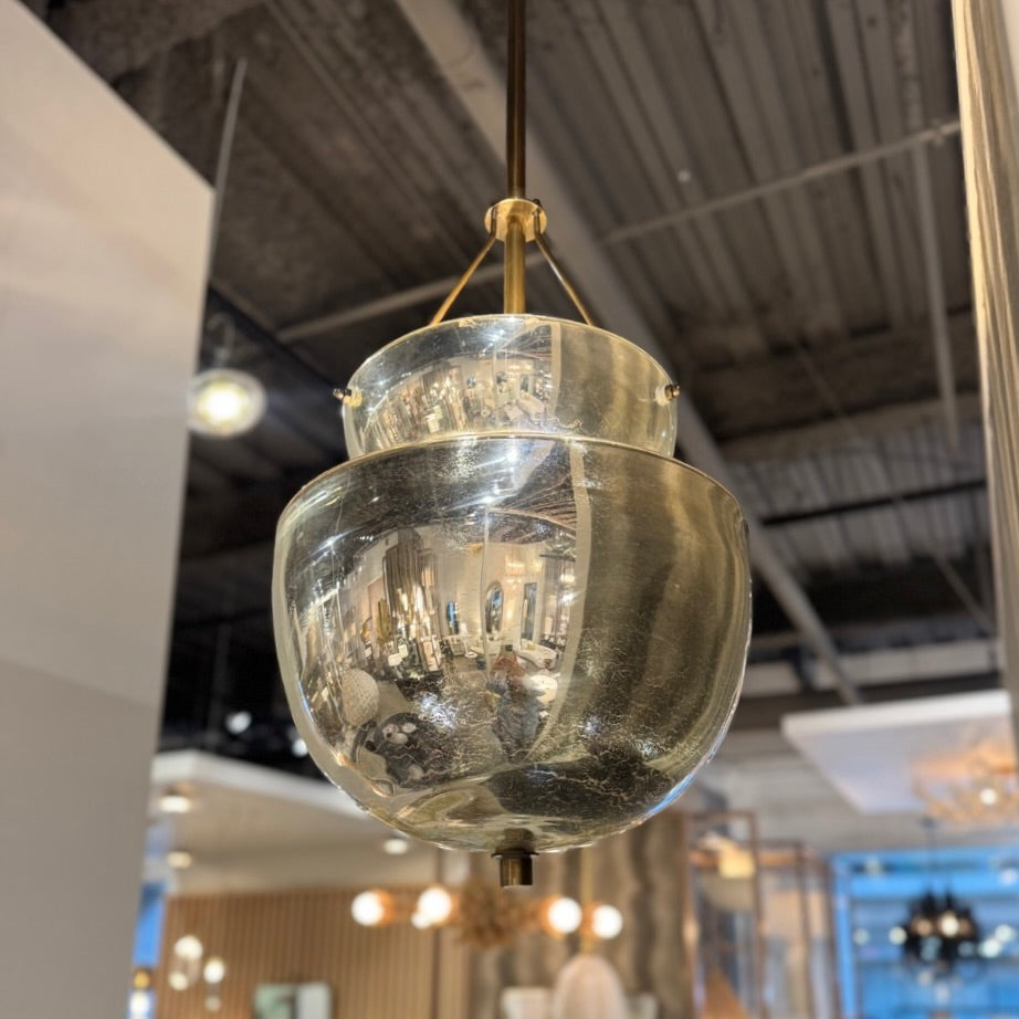 Glass pendant light fixture hanging in a modern indoor setting