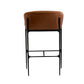 A modern bar stool featuring a warm brown leather cushioned seat and a black metal frame with a footrest, shown from the back against a plain white background.