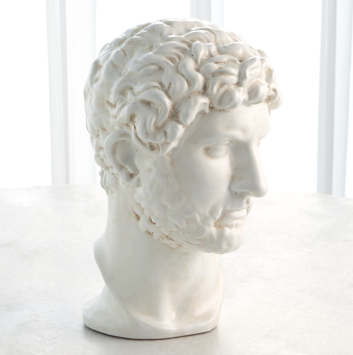 White classical bust sculpture on a light background