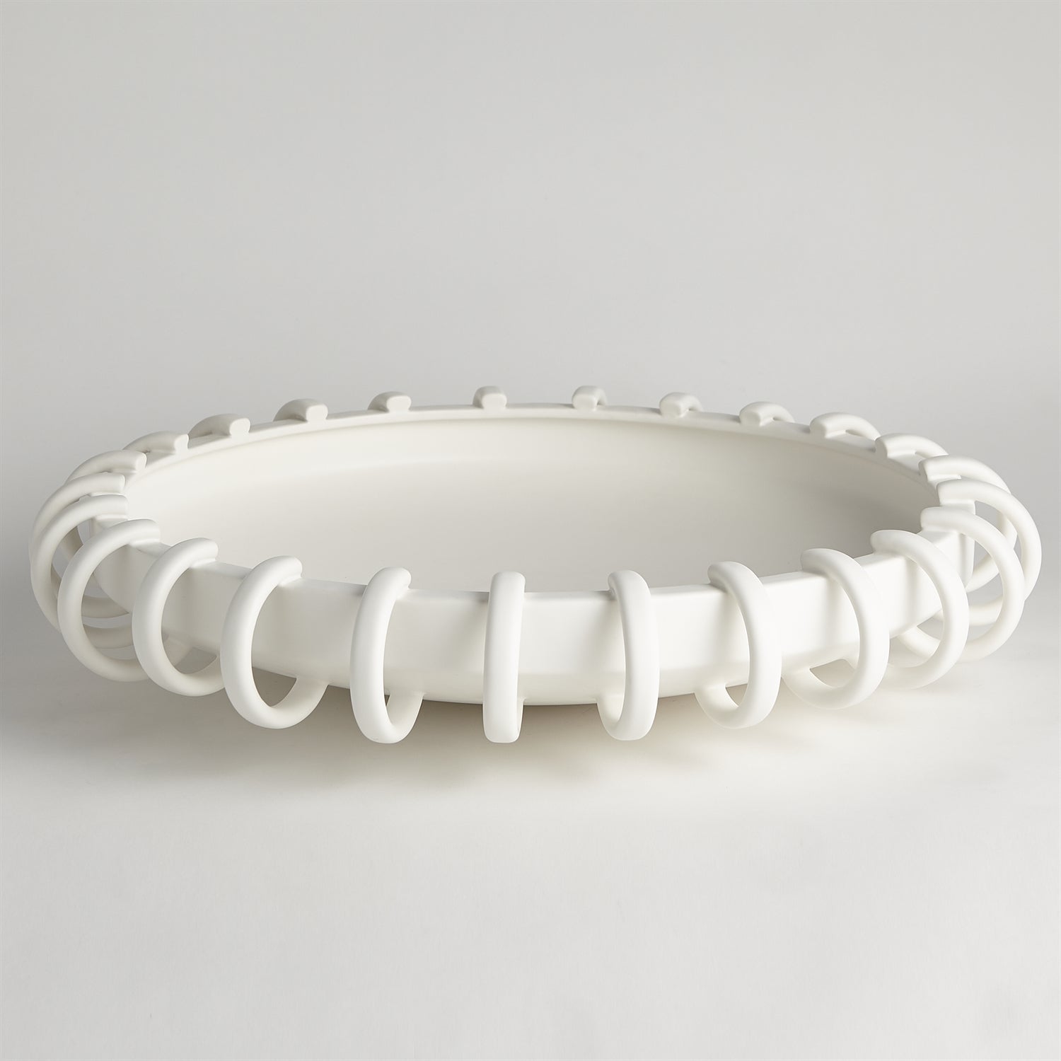 White ceiling light fixture with decorative design on a gray background