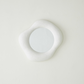 Round white light fixture on a white background