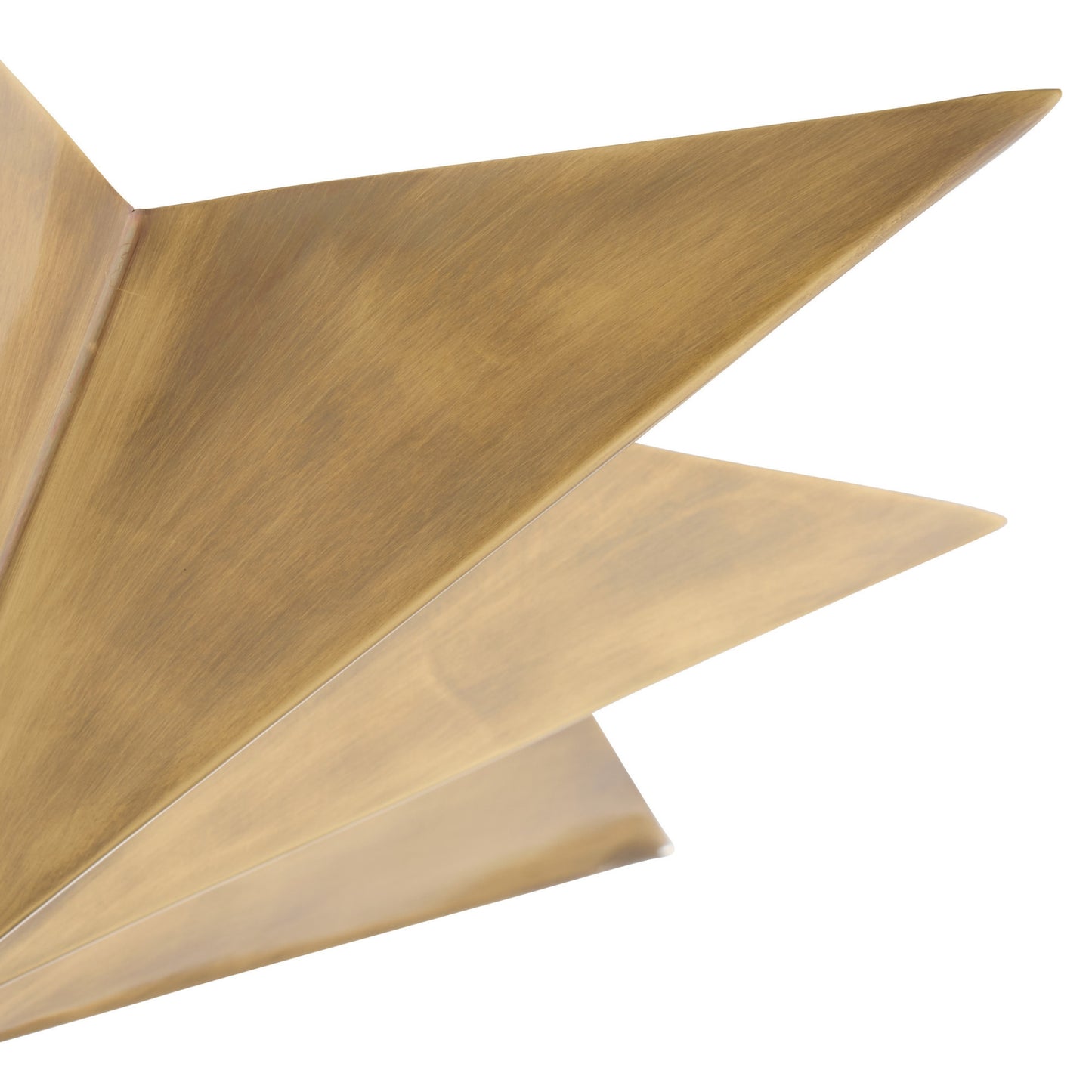 Gold metallic sculpture with geometric design on a white background