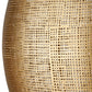 Close-up of a textured gold vase with a detailed pattern.
