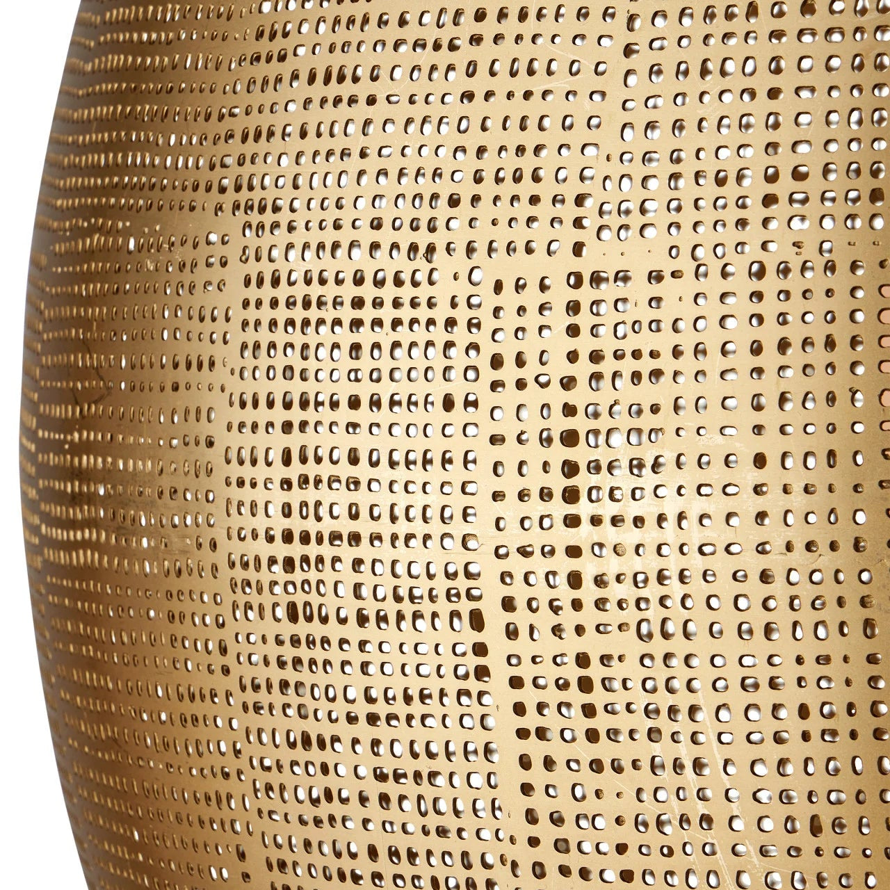 Close-up of a textured gold vase with a detailed pattern.
