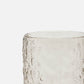 Clear glass with textured surface on a white background