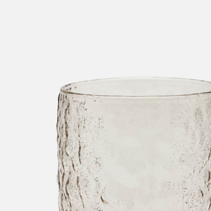 Clear glass with textured surface on a white background